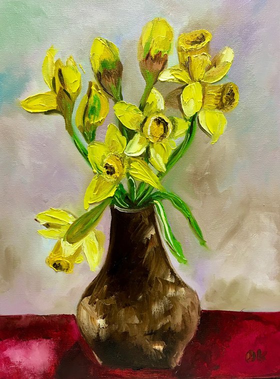 Bouquet of Daffodils on red table, still life inspired by spring.