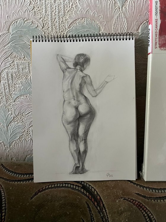 Nude woman figure from behind standing