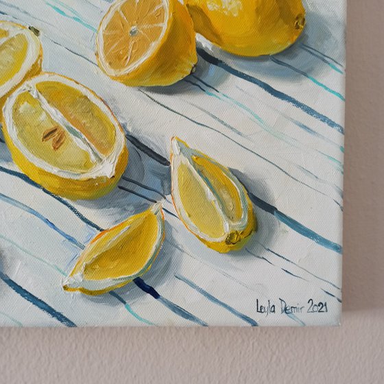 Lemons in glass bowl on stripen tablecloth