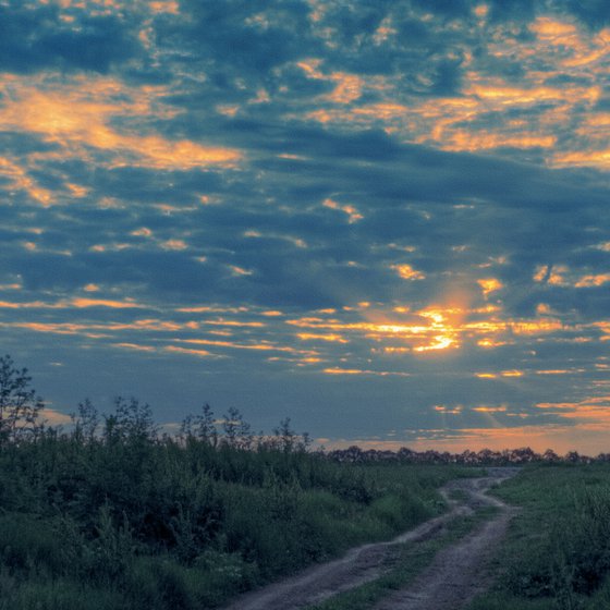 Flying clouds over the setting sun.