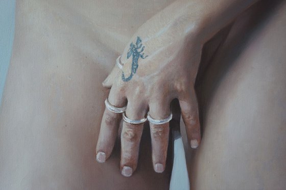 Nude standing. With hand and rings
