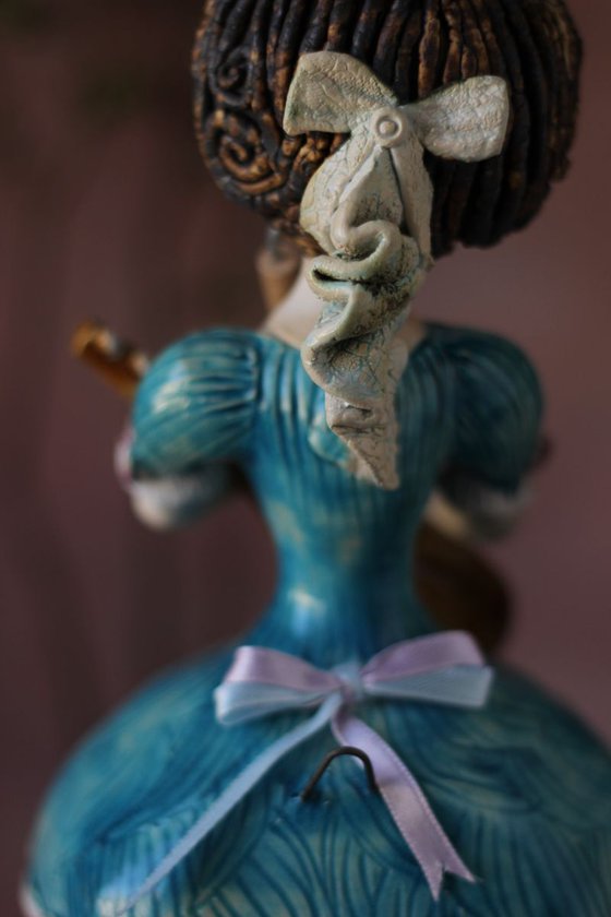 Blue dressed girl with mandolin. Wall ceramic sculpture by Elya Yalonetski.