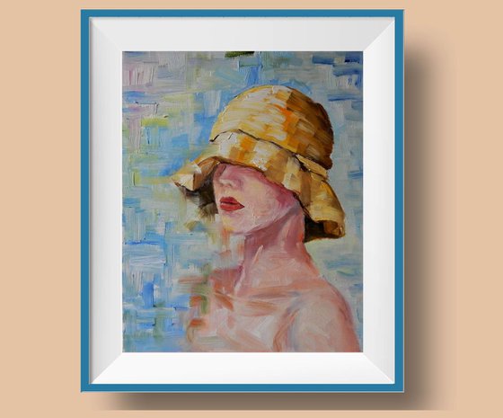 Portrait. Young lady in a yellow summer hat.