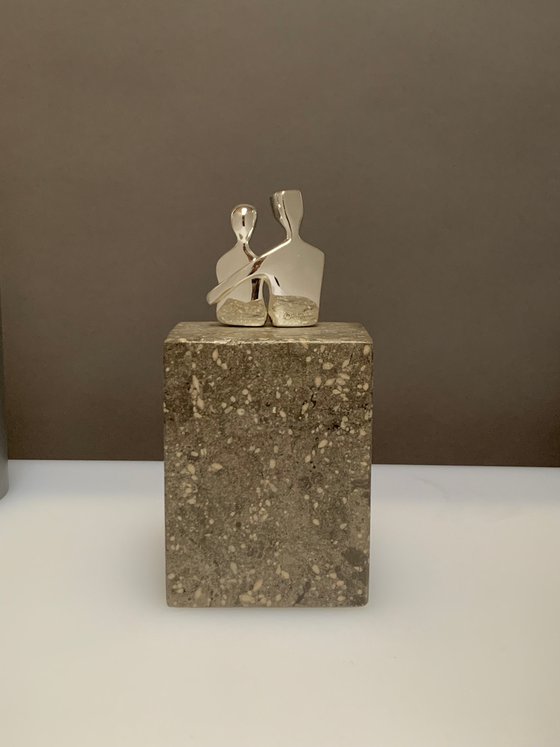 "Caress" a small  silver plated sculpture of a loving couple