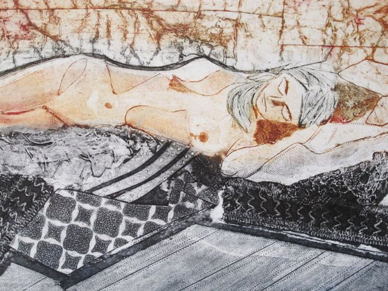 Reclining female nude. Sandy background