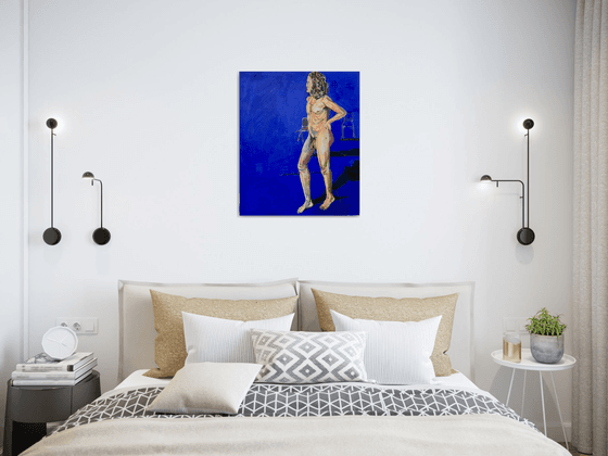 Young nude man in blue room
