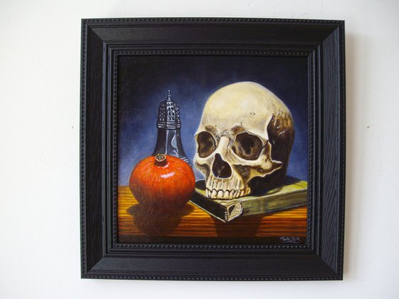 Skull on book with pomegranate