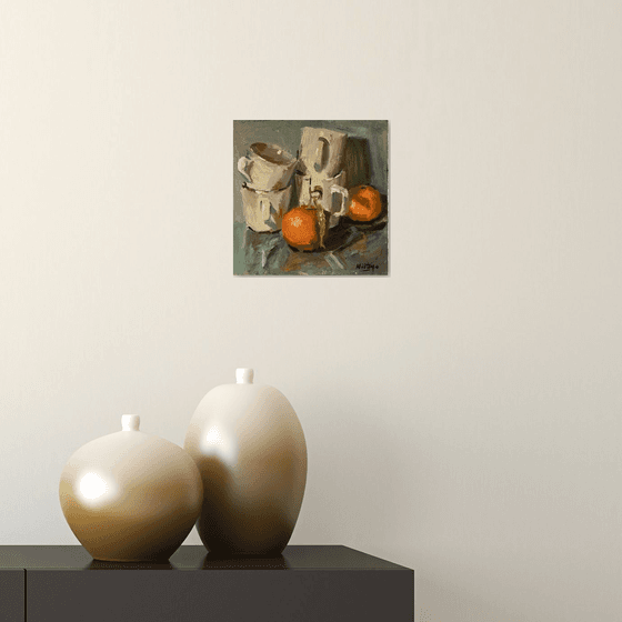 Stacked cups and oranges