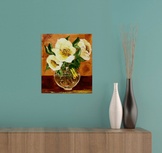 Bouquet of wild yellow roses in a vase on wooden table.