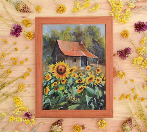 Old cabin with sunflower yard