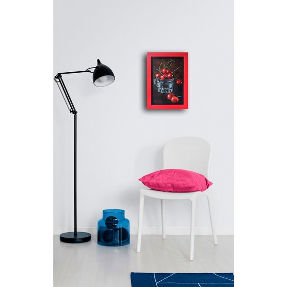 Red cherries in a metal cup