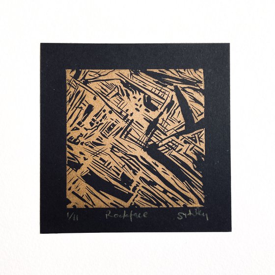 Rockface miniature linoprint in gold on black