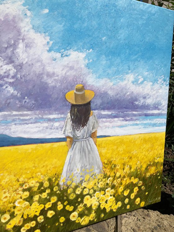 Summer. Woman in flower field