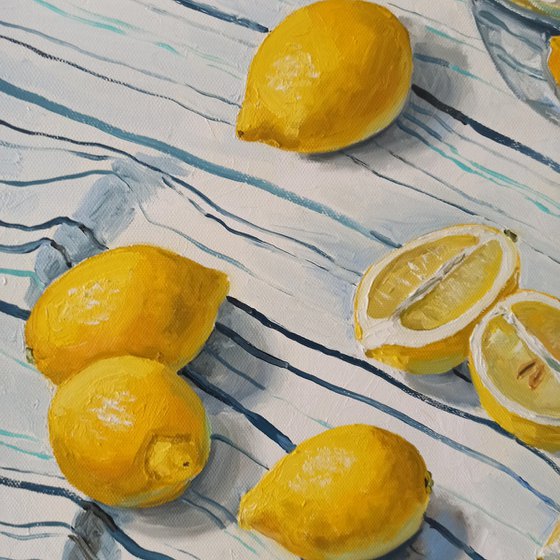 Lemons in glass bowl on stripen tablecloth