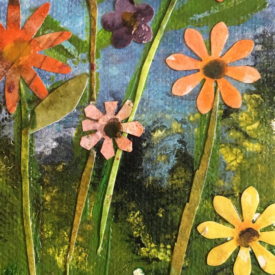 Flower meadow on blue canvas