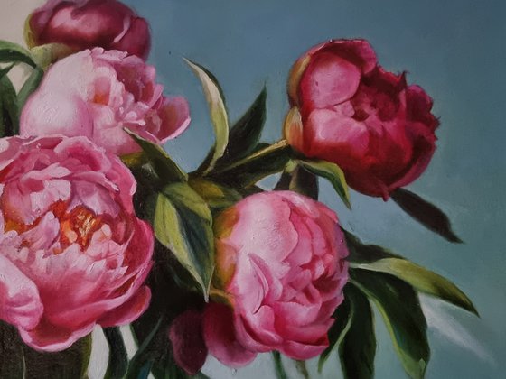 An armful of pink peonies.