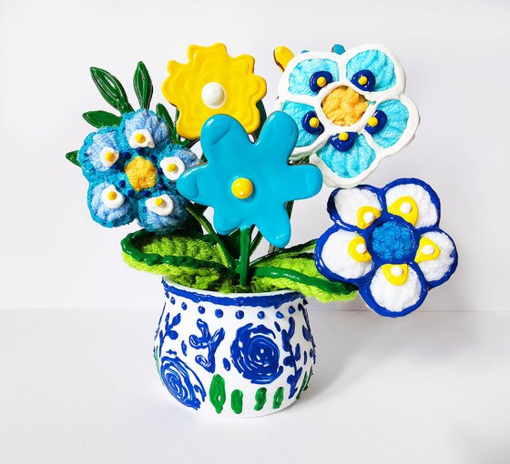 Blue crochet flowers in vase