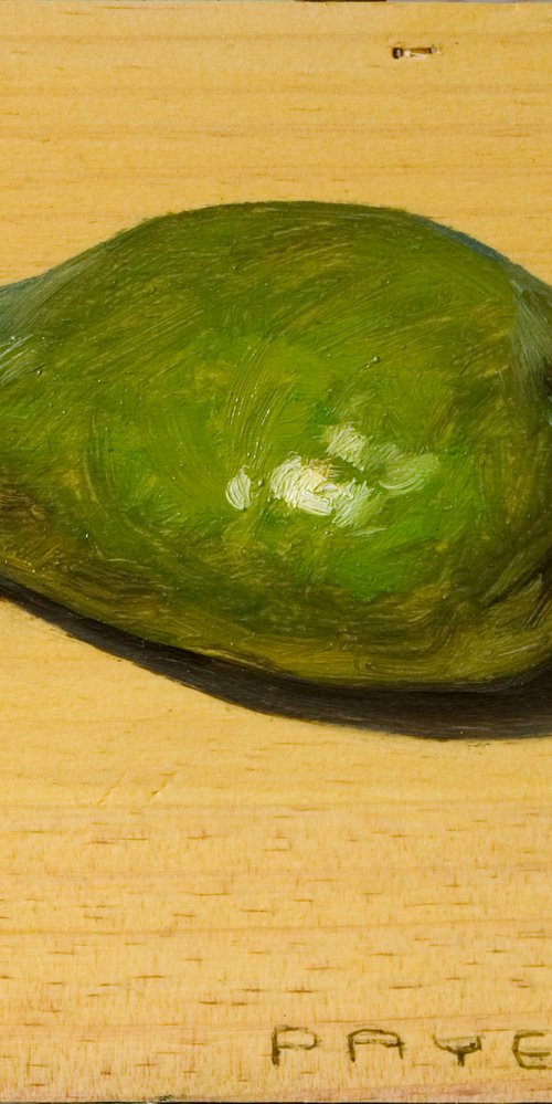 green avocado on a wood board for food lovers by Olivier Payeur