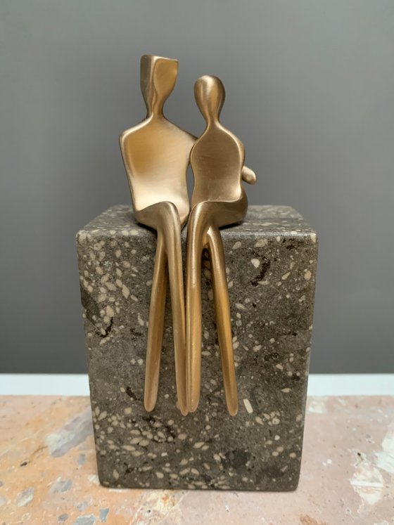 "Caress" a small bronze sculpture of a loving couple