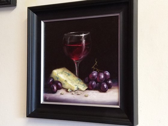 Red wine with cheese and grapes still life