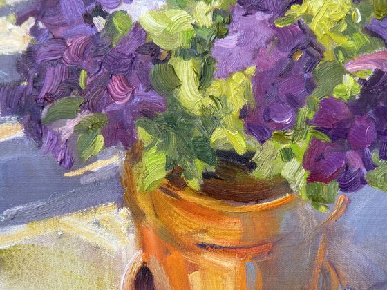 Violet flowers in Orange Pot