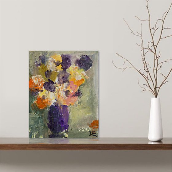 Small still life with orange and lilac flowers in the lilac vase