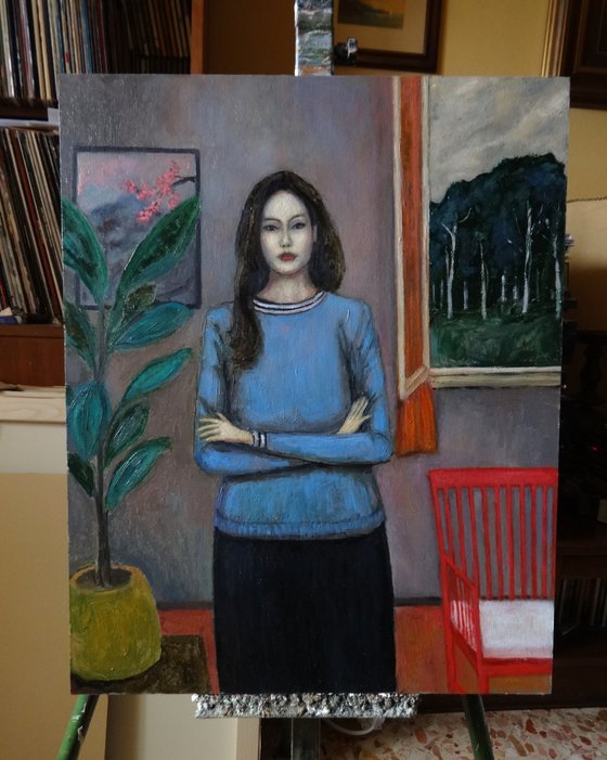 Woman with plant and red chair